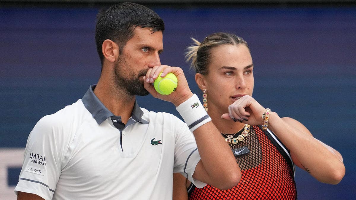 Novak Djokovic and Aryna Sabalenka speak during a mixed doubles tennis match at the US Open.
