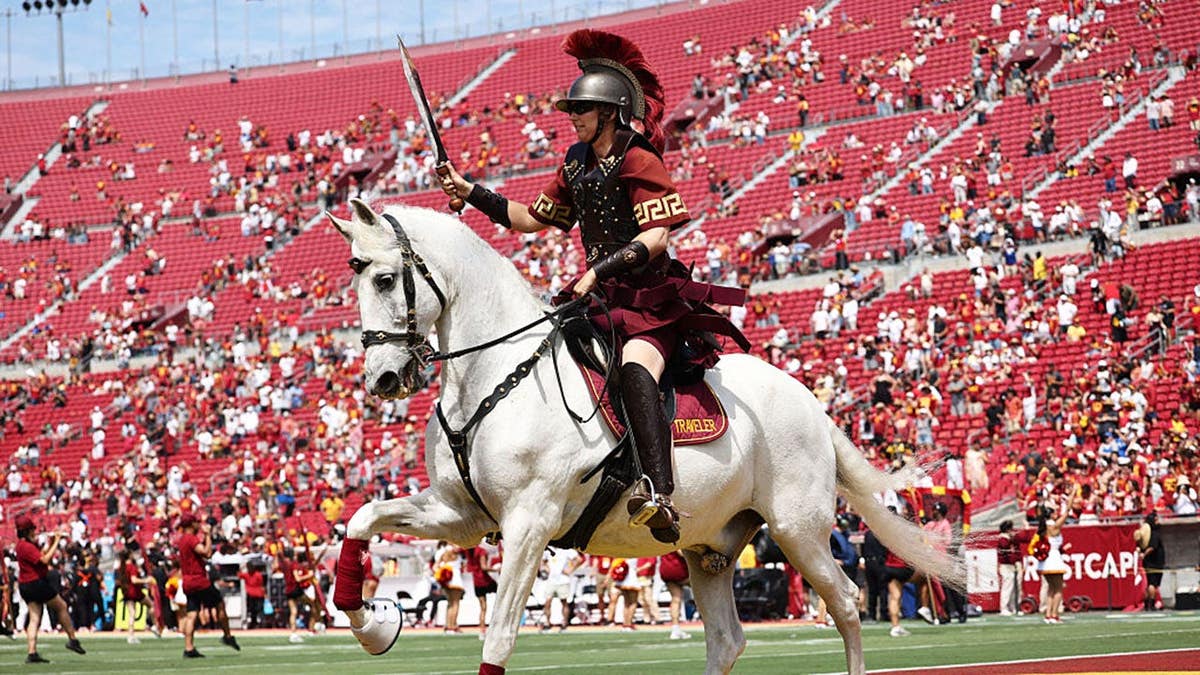 USC Trojans mascot Traveller trots through the end zone before a football game.