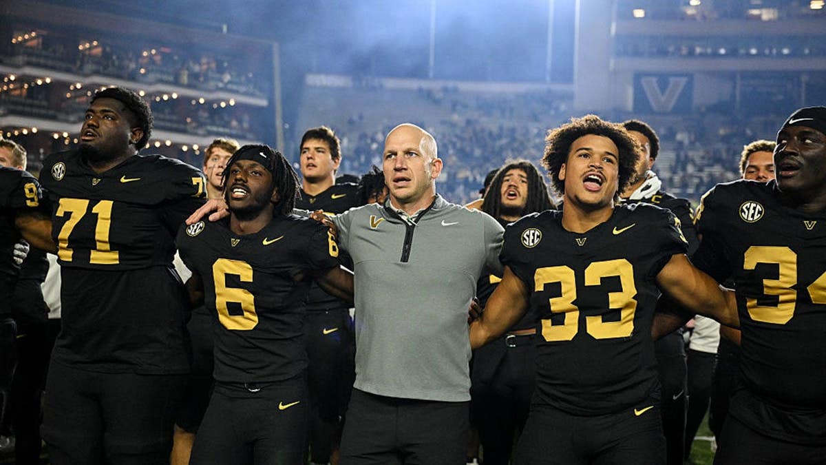 Clark Lea, Tre Richardson and Gabe Fields of Vanderbilt celebrate after beating Kentucky.
