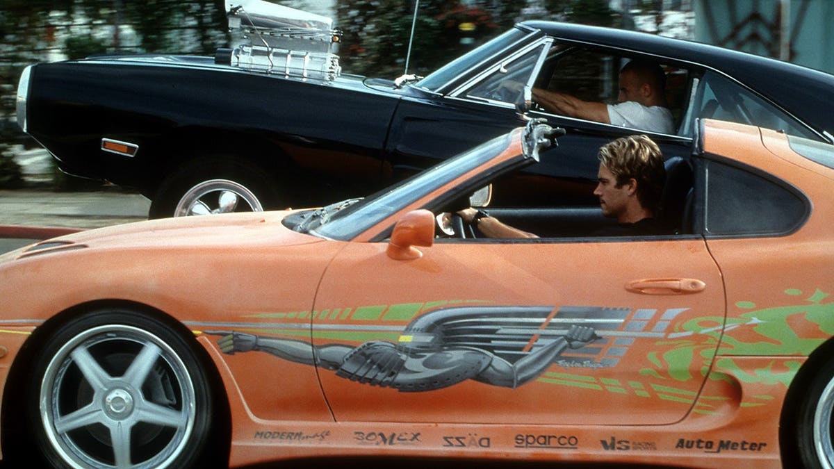 Vin Diesel and Paul Walker racing against each other in a scene from The Fast and the Furious.