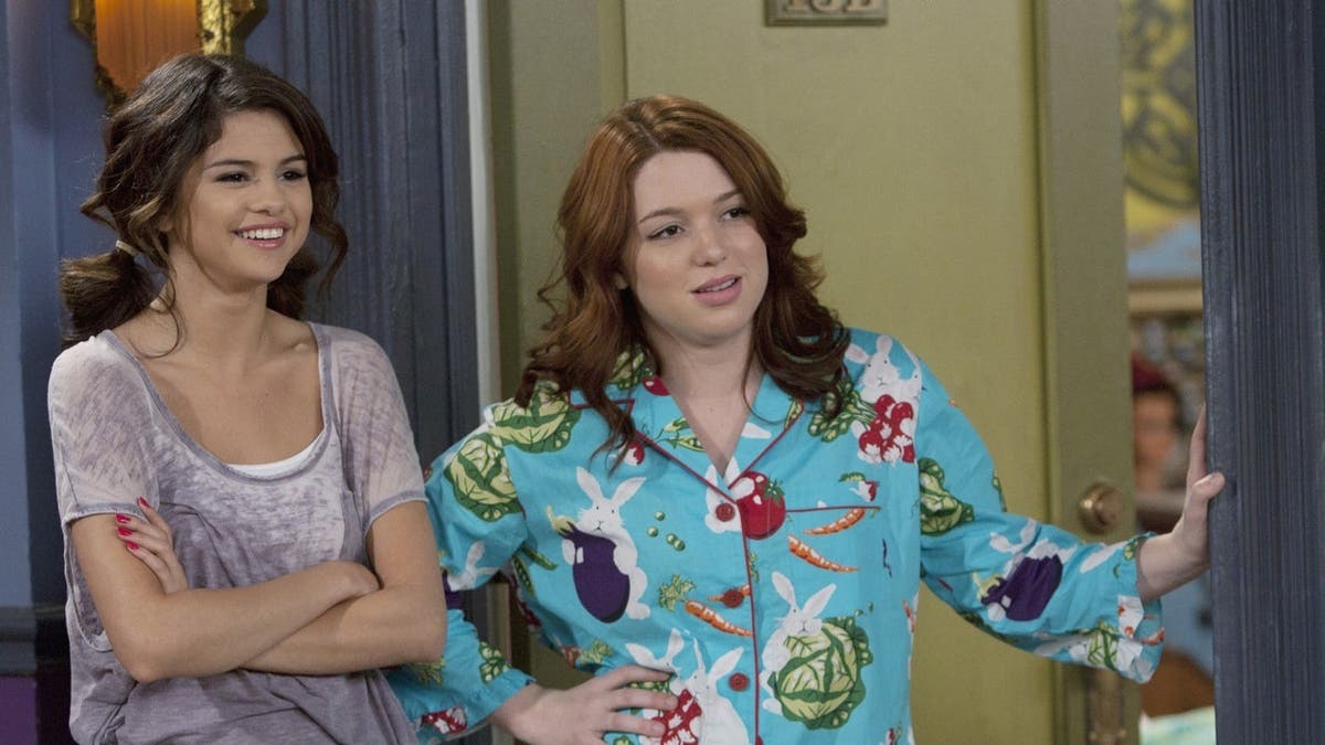 Selena Gomez and Jennifer Stone stand together in a scene from Wizards of Waverly Place.