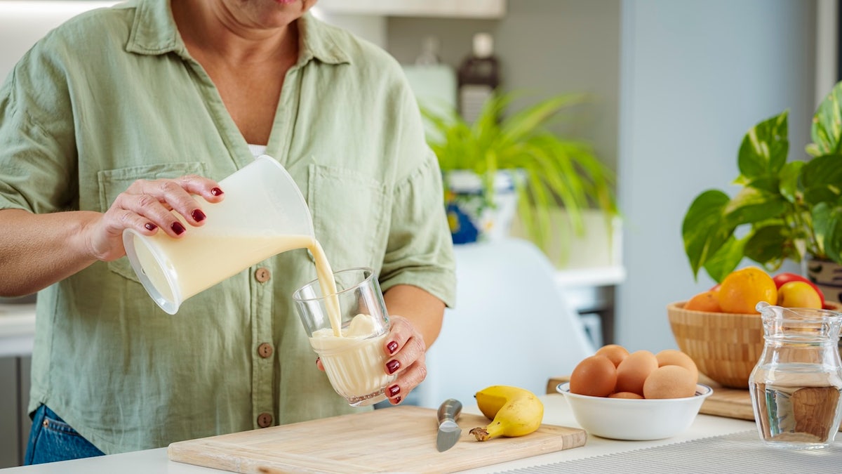 Woman pouring smoothie
