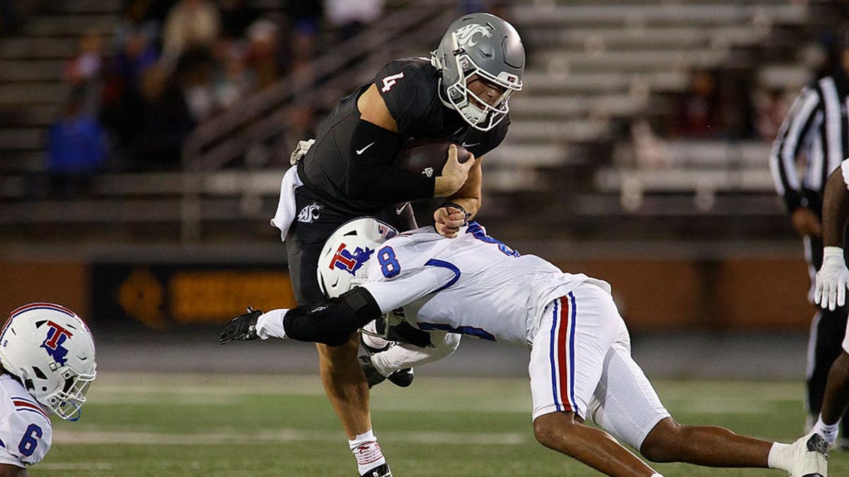 Zevi Eckhaus is tackled by Jacob Fields during a football game.