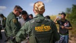 Border Patrol agents processing illegal immigrants.