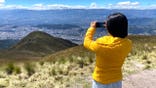 Woman taking picture of valley in Ecuador