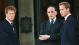 Jamie Lowther-Pinkerton speaking to Prince Harry and Prince William in dark suits.
