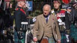 King Charles in formal Scottish clothing inspecting a regiment.