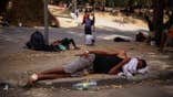 Migrants wait outside Ceuta's temporary migrant cente