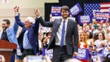 U.S. Senate candidate Abdul El-Sayed, left, U.S. Sen. Bernie Sanders, center, and U.S. House candidate William Lawrence, right, at a rally in Lansing, Mich., on July 19, 2026.