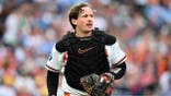 Adley Rutschman #35 catches for the Baltimore Orioles against the Kansas City Royals.