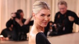 Amanda Kloots poses on the red carpet at the Golden Globes.