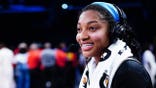 Angel Reese #5 talks to media after breaking WNBA single-game rebound record.