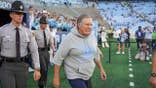 Bill Belichick walks onto the field at Kenan Stadium.