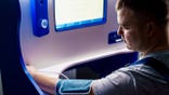 A person using a blood pressure cuff