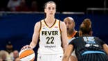 Caitlin Clark dribbles the ball against Sydney Taylor during a WNBA game.
