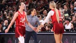 Caitlin Clark #22 and Sophie Cunningham #8 high five during an Indiana Fever game.