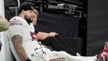 Chase Bisontis, Arizona Cardinals offensive lineman, is carted off the field during a preseason NFL game.