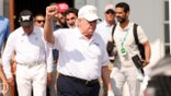 President Donald Trump holds his fist in the air