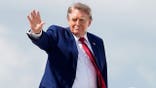 Donald Trump waves as he boards Air Force One at Joint Base Andrews.