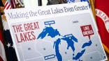 Signage reading "Making the Great Lakes Even Greater" displayed in the Oval Office during an executive order signing.