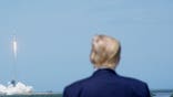 Donald Trump watches a SpaceX Falcon 9 rocket lift off at Kennedy Space Center.