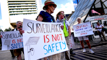 Protesters march against Flock Safety license plate cameras in Boston.