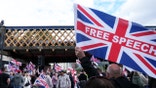 Supporters of British activist Tommy Robinson walk through central London waving flags during a 'Free speech' march, on September 13, 2025.