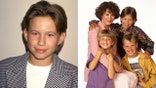 Jonathan Taylor Thomas stands with the Home Improvement cast in a posed promotional portrait.