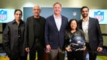 NFL Commissioner Roger Goodell and the Khosla family pose for a portrait at an NFL owners meeting.