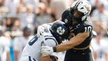 Langston Patterson #10 sacks Bryson Barnes #16 during a football game.