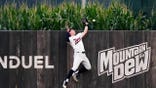 Luke Keaschall of the Minnesota Twins reaches as Kyle Schwarber of the Philadelphia Phillies hits a home run.