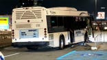 shuttle bus rests against a concrete barrier after the crash