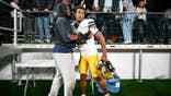Nik Bonitto hugs his godbrother Zayden Gamble after a game in London.