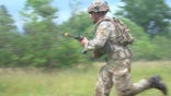 U.K. soldier runs during Northern Strike training in Michigan.