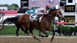 Jockey Umberto Rispoli crosses the finish line on Journalism #2 at Pimlico Race Course.