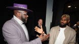 Shaquille O'Neal and LeBron James high five before the NBA All-Star Game.