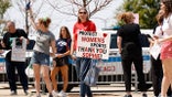 Sophie Cunningham supporter carries a sign