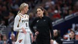 Sophie Cunningham and head coach Stephanie White stand during an Indiana Fever game.