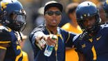 Stedman Bailey talks with Shelton Gibson during warmups at Mountaineer Field.