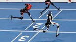 Tiangong Ultra humanoid robot crosses finish line next to Honor robots during 100-meter race.