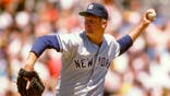 Tommy John pitches for the New York Yankees against the Oakland Athletics.
