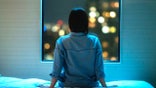 Woman at window can't sleep