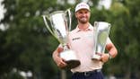 Wyndham Clark of the United States poses with the trophy on the 18th green after winning the BMW Championship