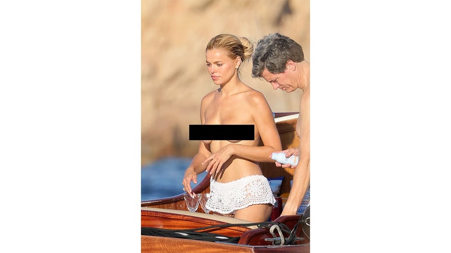 Brooks Nader looks out as she stands on a boat in Italy