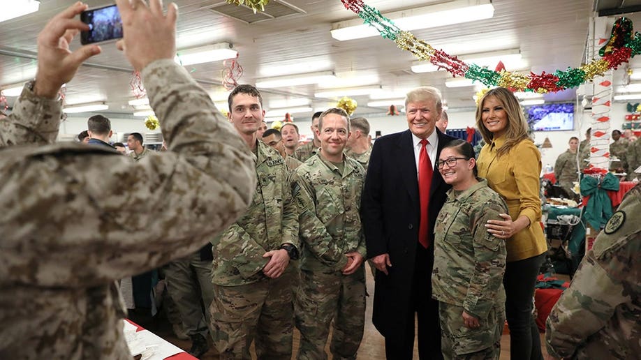 U.S. President Trump and the First Lady greet military personnel at the dining facility during an unannounced visit to Al Asad Air Base, Iraq