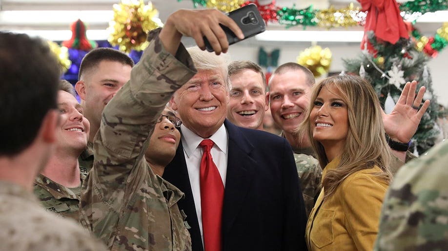 4fb3041d-U.S. President Trump and the First Lady greet military personnel at the dining facility during an unannounced visit to Al Asad Air Base, Iraq