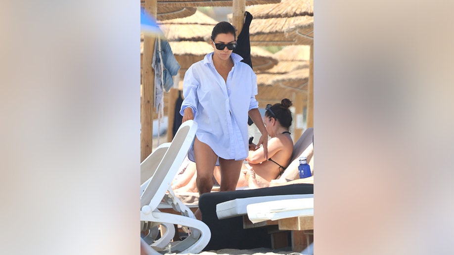 Eva Longoria eventually covered up with a white shirt as she wrapped up her day at the beach.