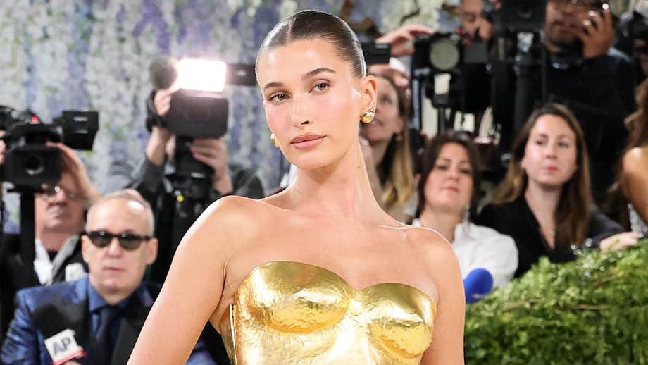 Hailey Bieber shows off toned figure in tiny yellow bikini while sharing summer snaps