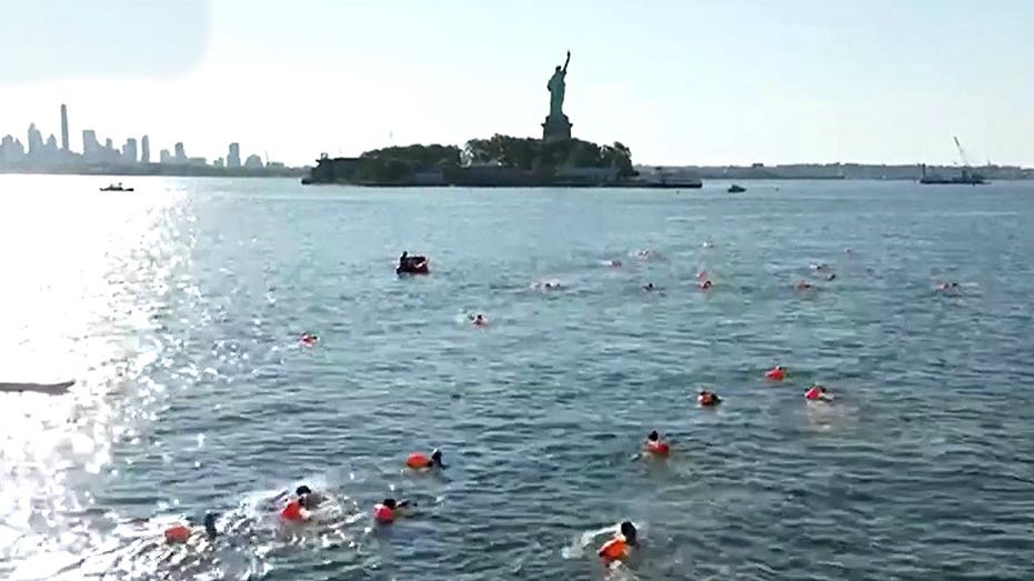 Retired Navy SEALS plunge into New York Harbor for patriotic swim honoring service and sacrifice
