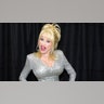 Dolly Parton smiling in a silver dress in 2004.